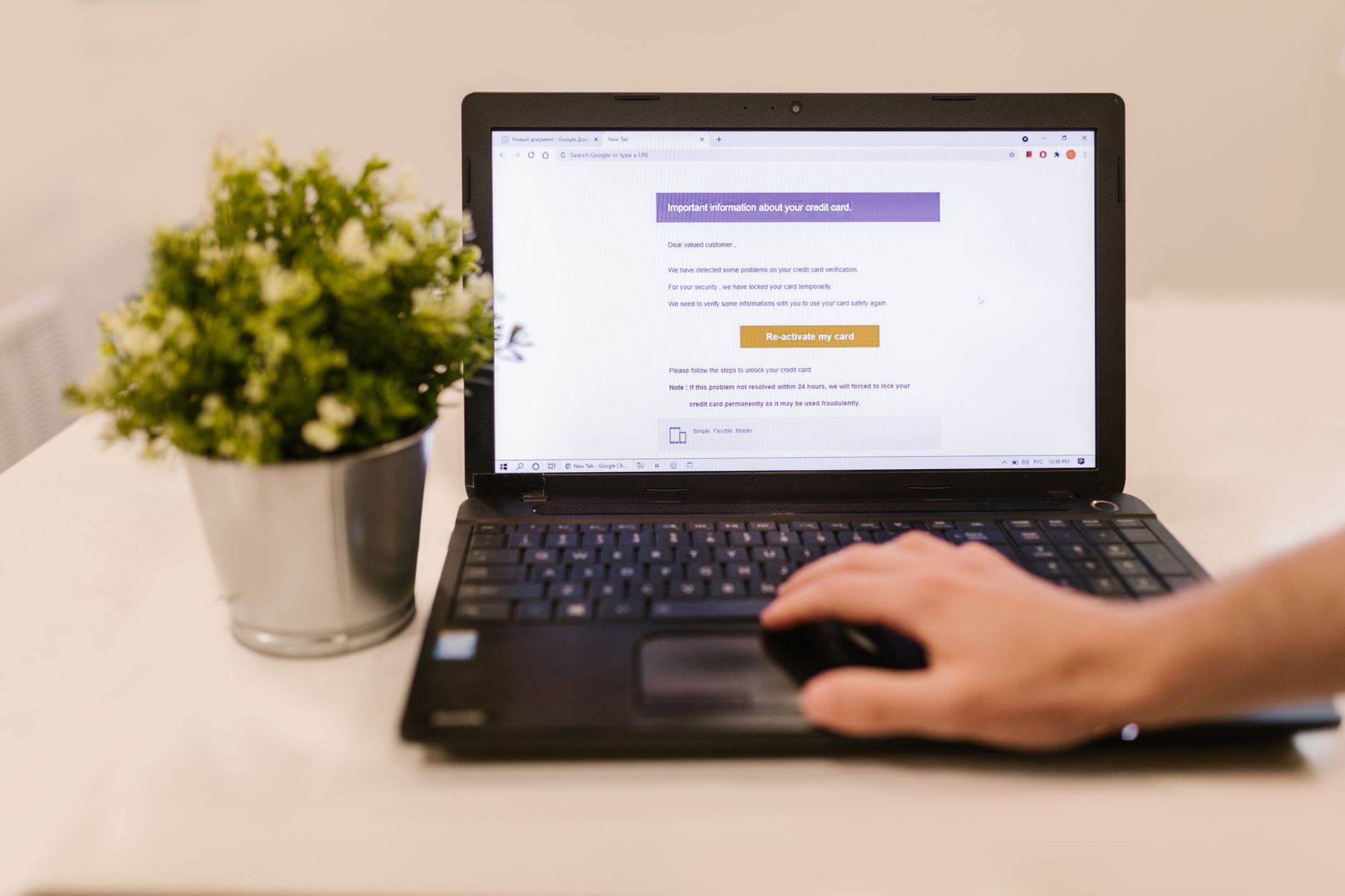 A person reviews their credit report on a computer screen while holding a credit card.